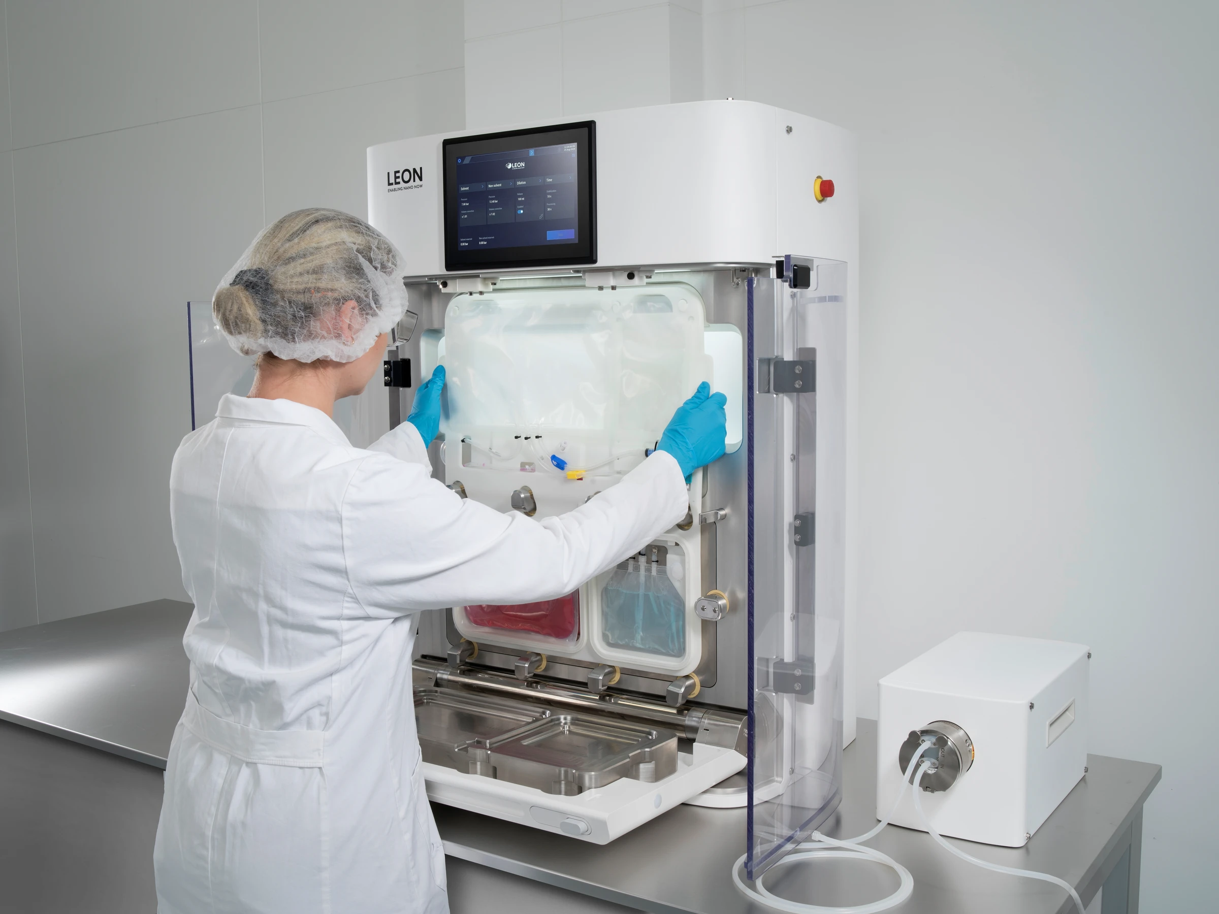 Technician loading a disposable cassette into the NANOme® system